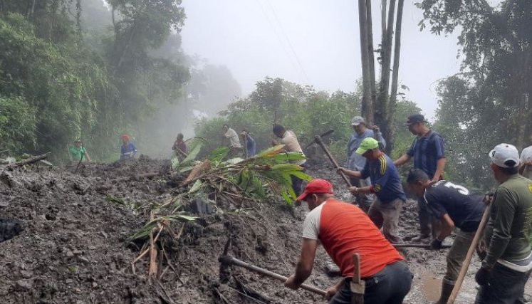 Campesinos con picas y palas despejan el lodo y las rocas que cayeron sobre la carretera/Foto cortesía