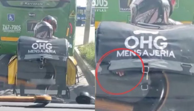 Domiciliario lleva a una niña en un bolso